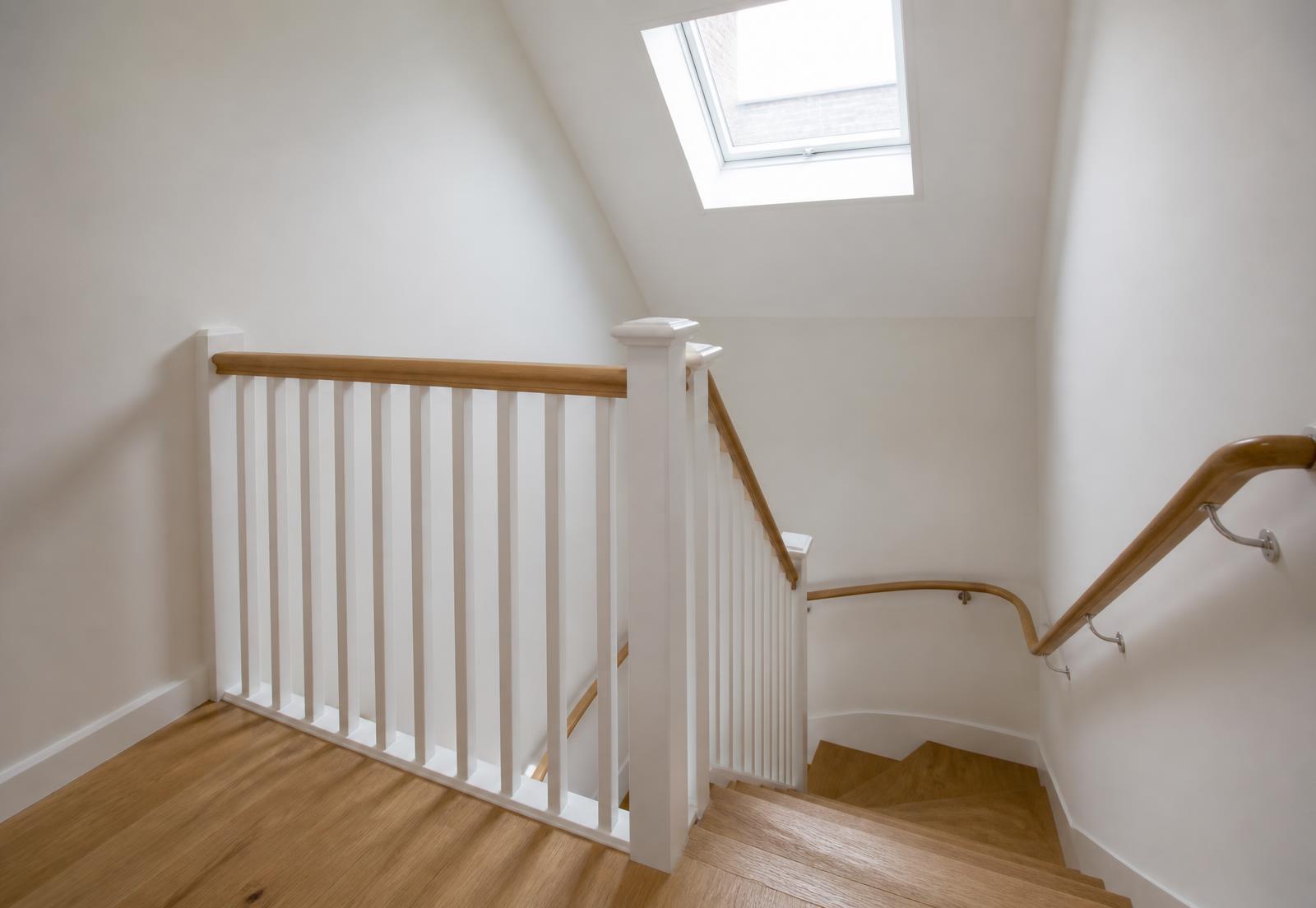 New oak staircase and loft landing with painted balustrade and rooflight above